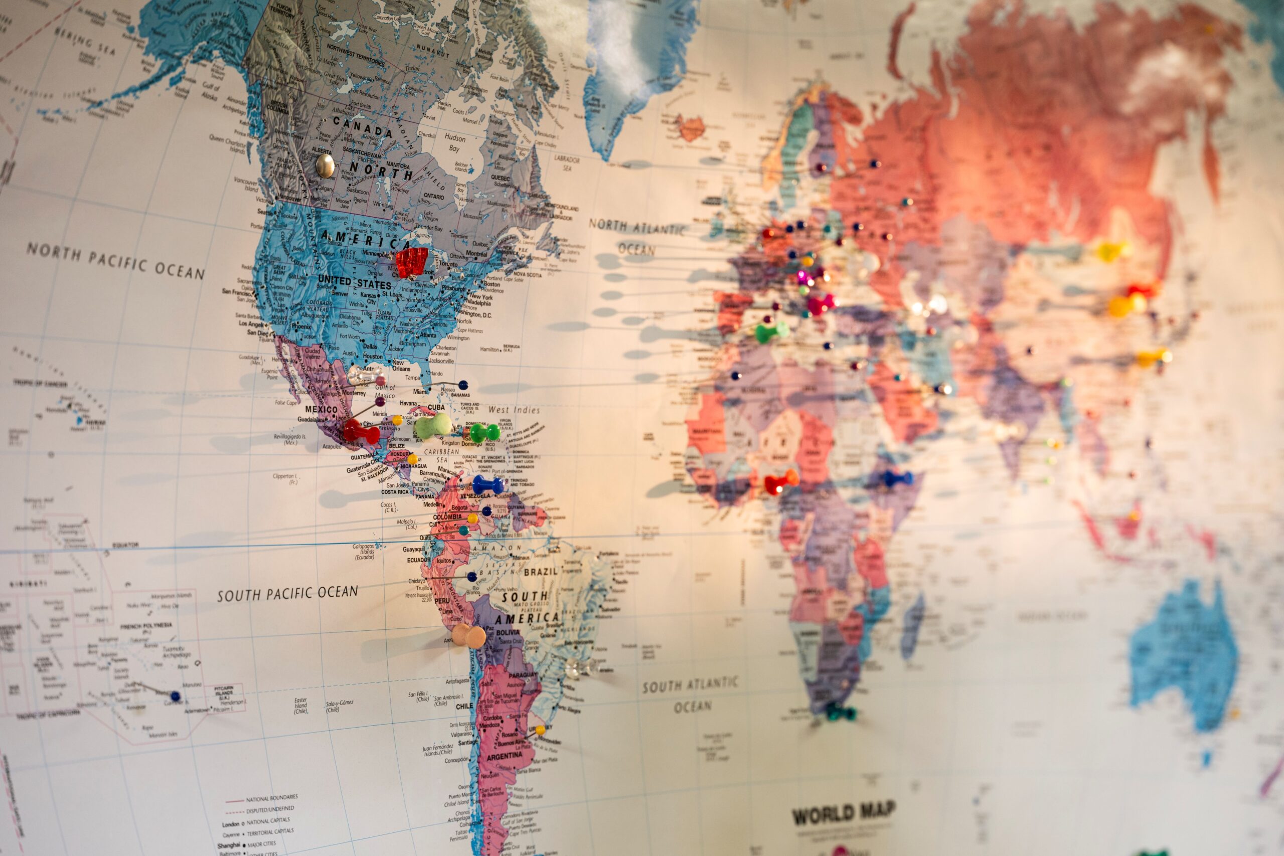 World map with colored pins dotted around